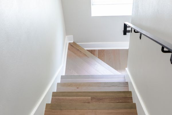 A close-up showing the wooden stair treads and the white painted risers.