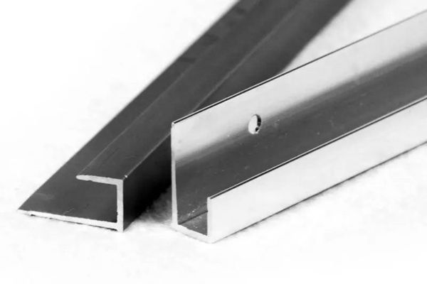 A stack of aluminum J-channels showing their metallic finish.